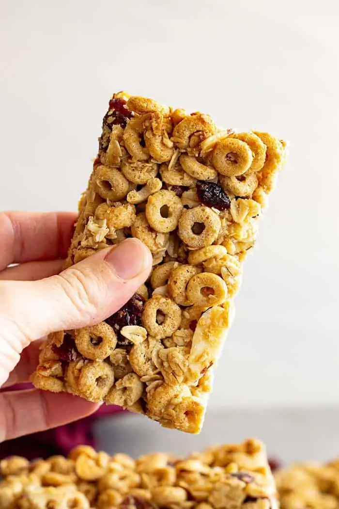 Hand holding a cheerio granola bar. 