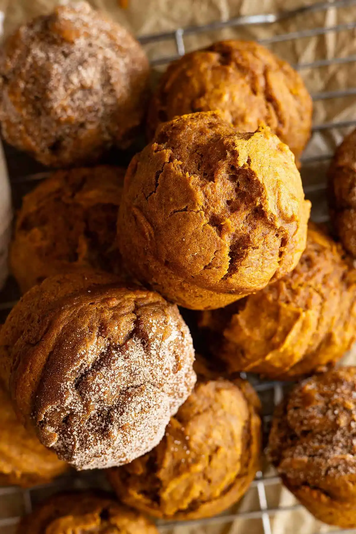 Overhead view of several pumpkin muffins piled together.