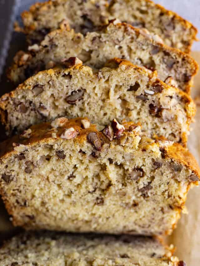 Close up of slices of banana nut bread to show the texture and nuts inside.