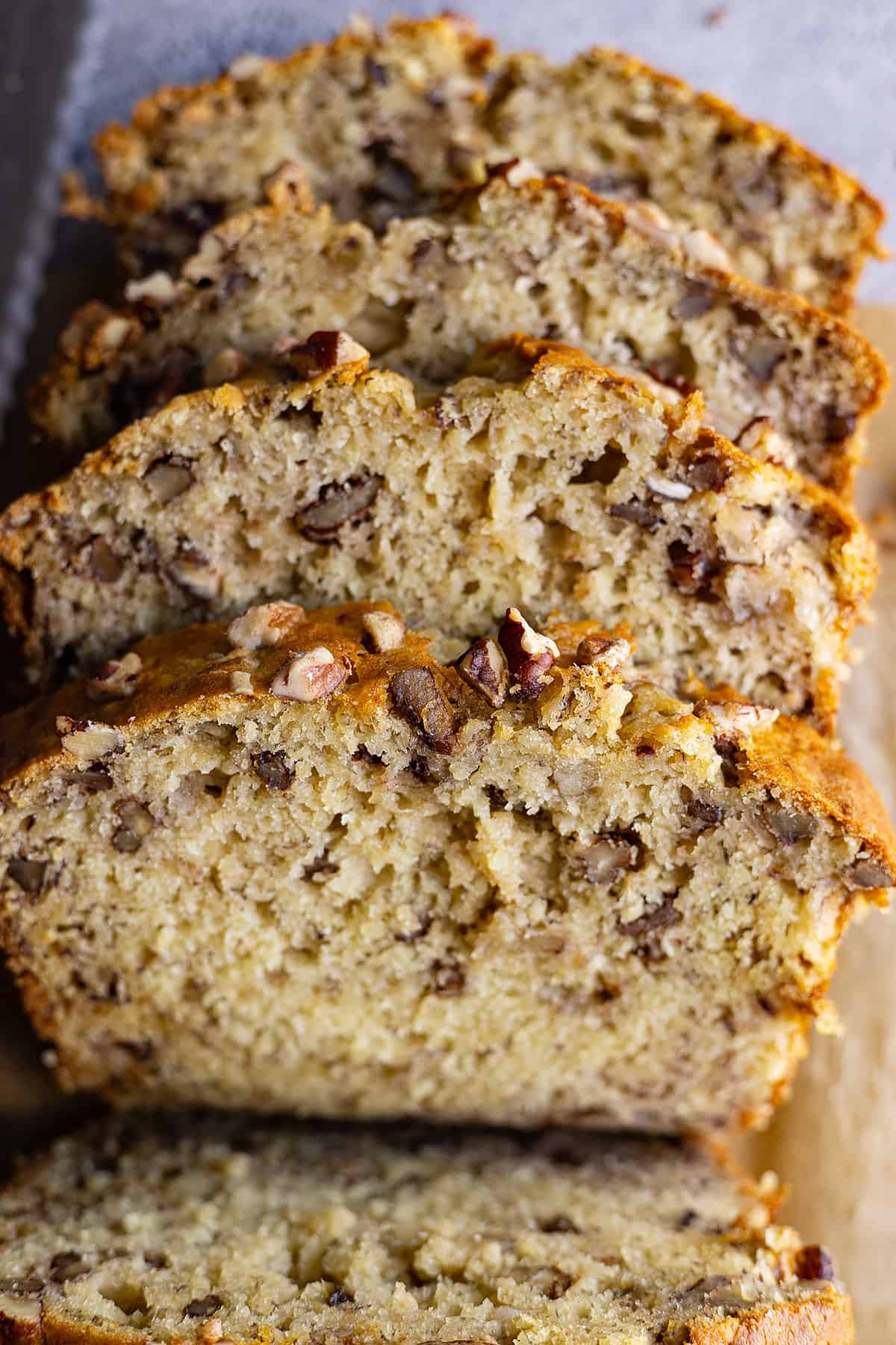 Close up of slices of banana nut bread to show the texture and nuts inside. 