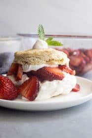Strawberry Shortcake on a white plate. Juicy strawberries and freshly whipped cream.