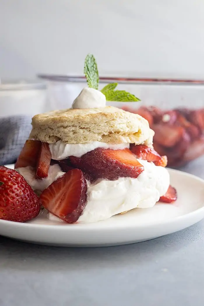 Strawberry Shortcake on a white plate. Juicy strawberries and freshly whipped cream. 