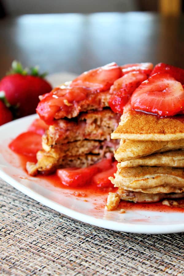 Whole Wheat Strawberry Pancakes with strawberry syrup on top