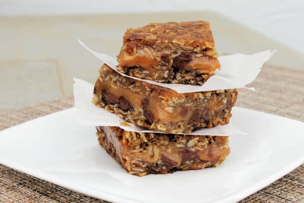 carmeltia Chocolate Caramel bars stacked on top of each other with parchment paper between