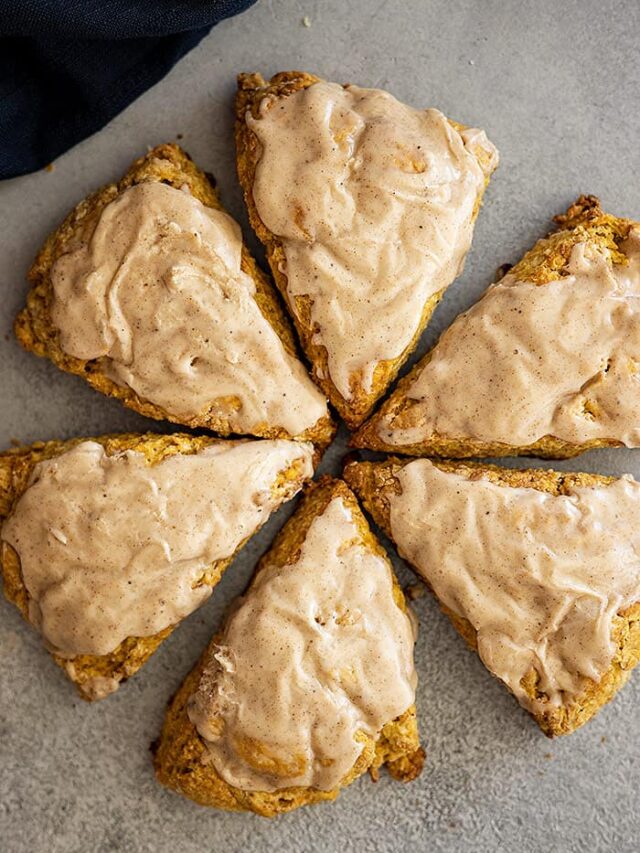 Overhead view of scones frosted and arranged in a circle with points to the middle.