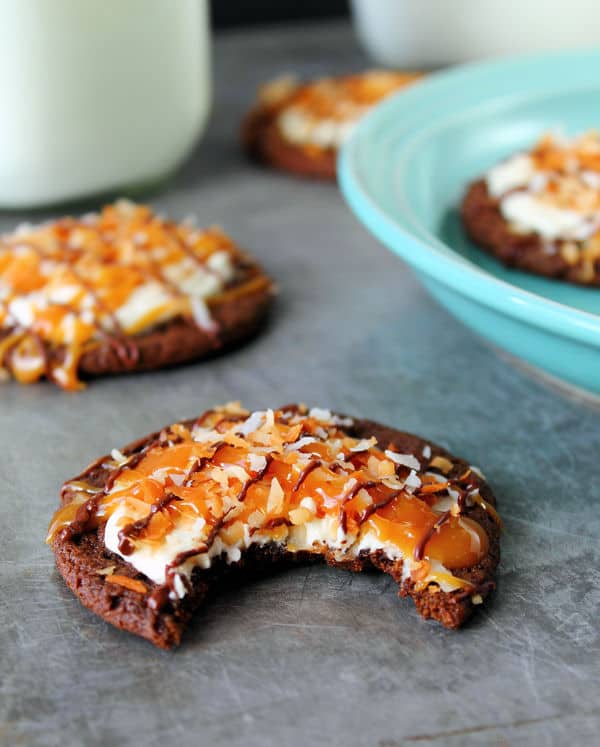 Chocolate Samoa Cookie with caramel and coconut topping and a bite taken out of it
