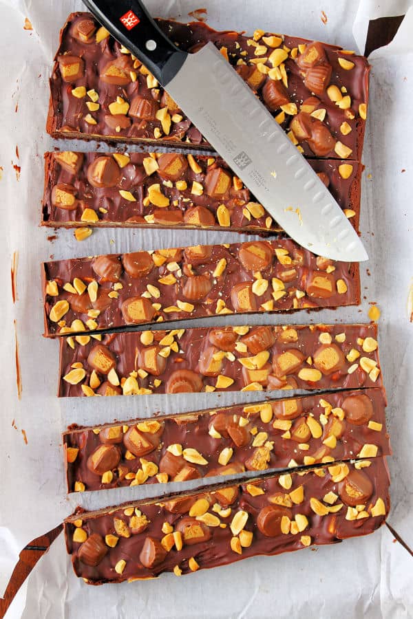 Peanut Butter Caramel Brownies cut into thin slices in the baking pan