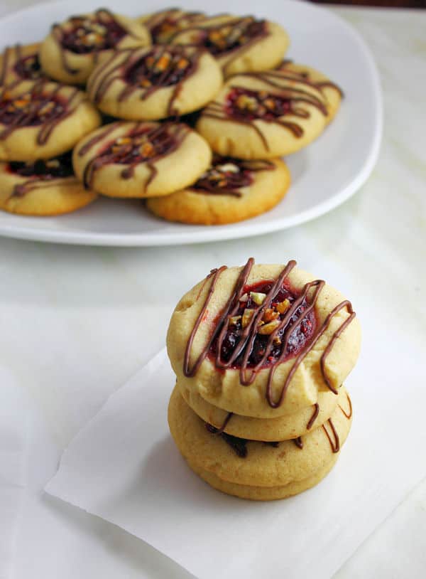 Raspberry Thumbprints with chocolate drizzle and chopped nut topping