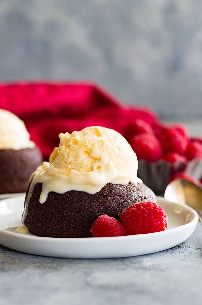 Chocolate Molten Lava Cake topped with ice cream and raspberries. 