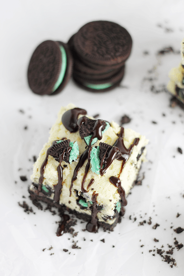 Mint Oreo Cheesecake Bar drizzled with hot fudge