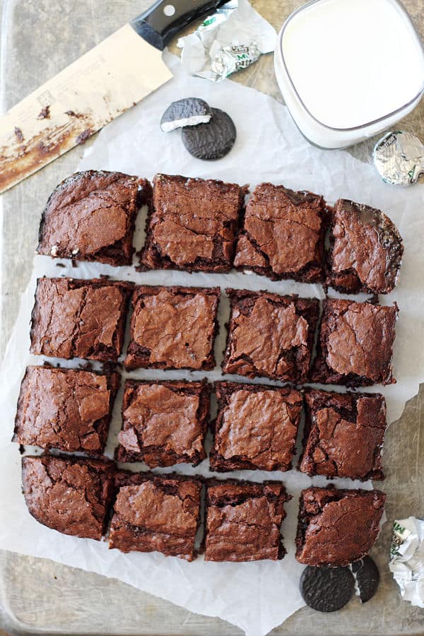 Peppermint Patty Brownies cut into squares on parchment paper