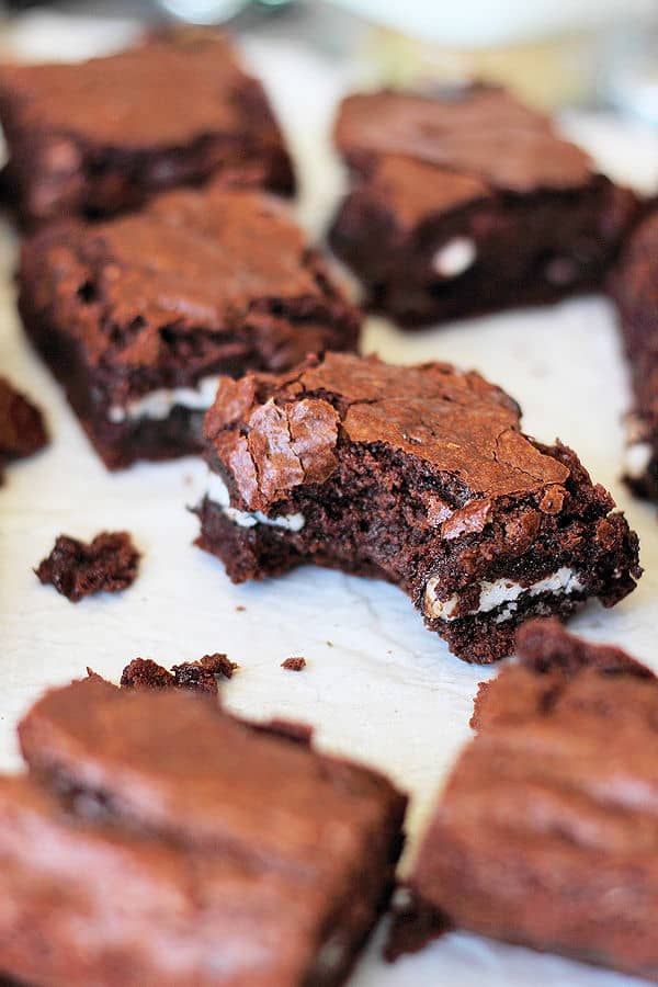 squares of peppermint patty brownies with the focus on one square with a bite taken out of it 