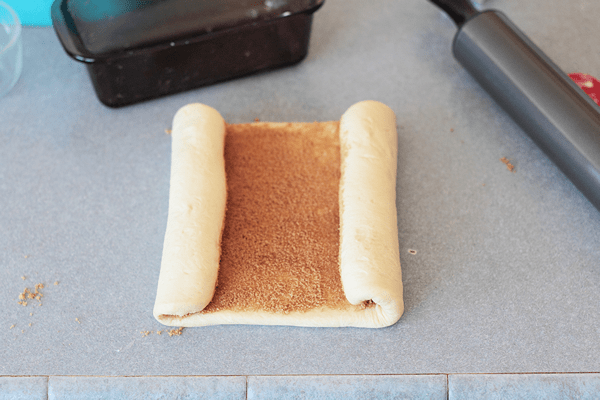 rolling cinnamon sugar in bread dough 