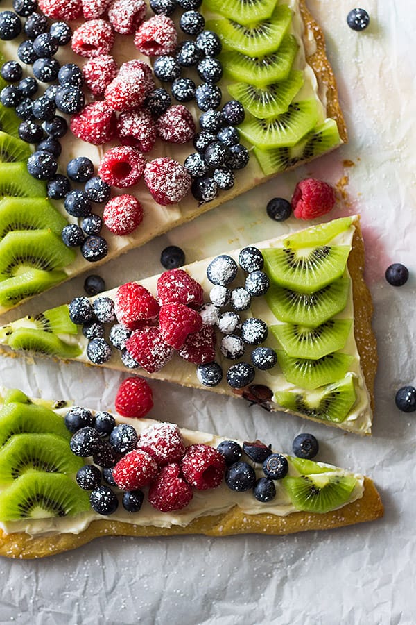 This Easy Fruit Pizza is made with a crescent sheet instead of sugar cookie dough. Then topped with sweetened cream cheese and lots of fruit!