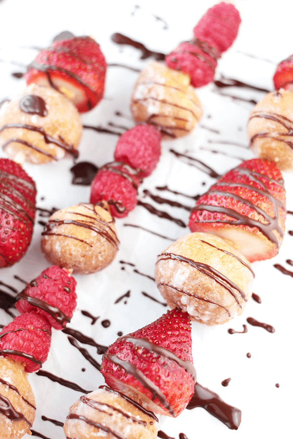 donuts and strawberries skewered and drizzled with chocolate