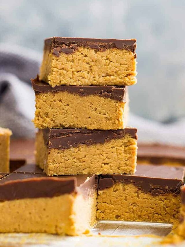 No bake chocolate peanut butter bars stacked on top of each other in a tall tower.