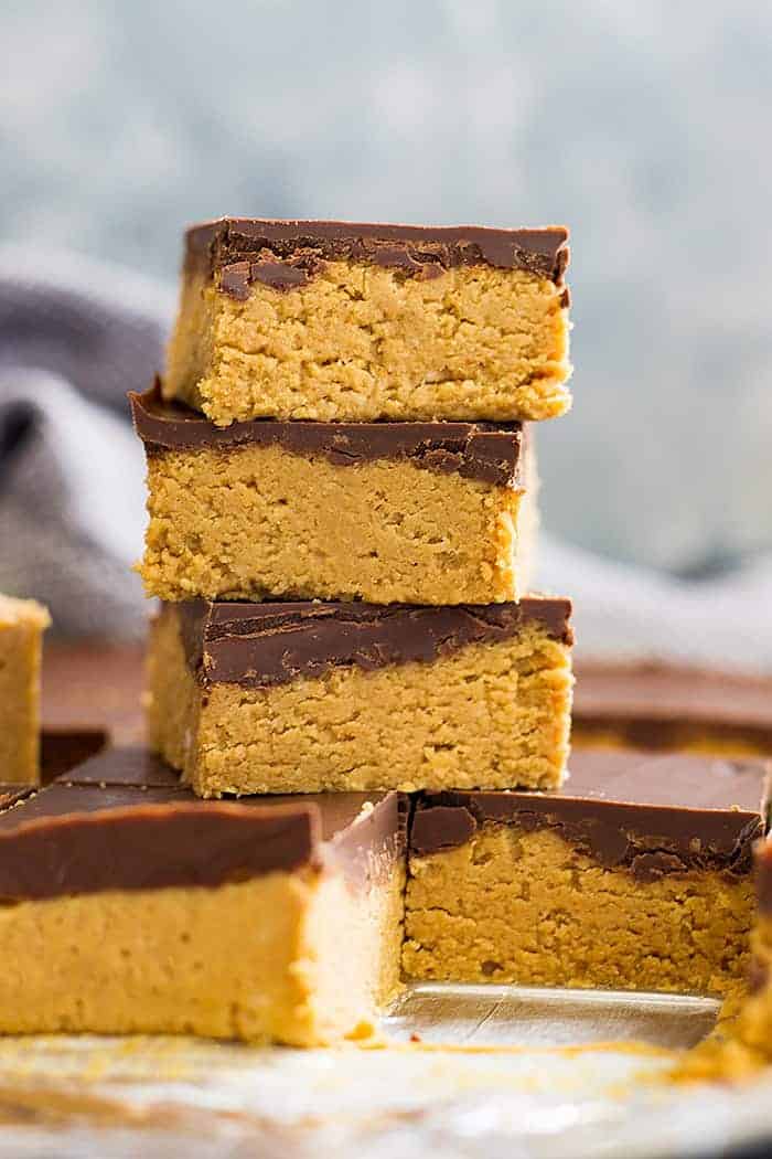 No bake chocolate peanut butter bars stacked on top of each other in a tall tower.