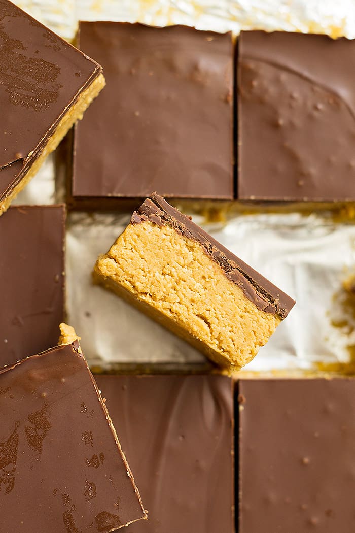 No bake chocolate peanut butter bars cut into squares with one turned on its side. 