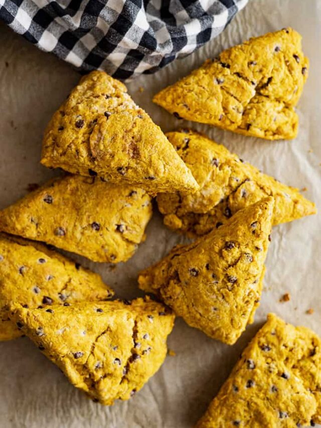 Overhead view of pumpkin chocolate chip scones on a piece of parchment paper.