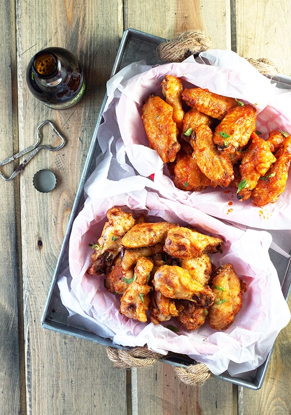 Baked Garlic Sriracha Wings- these wings are baked to crispy perfection then either coated in a garlic sriracha dry rub or sauce! | countrysidecravings.com