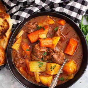 This Hearty Beef Stew is comfort food to the max! It's and easy beef stew recipe that's filled with fall apart tender beef in a wonderful hearty sauce. #beef #beefstew #easyrecipe #slowcooker