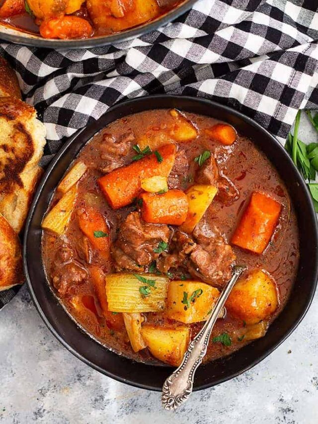 This Hearty Beef Stew is comfort food to the max! It's and easy beef stew recipe that's filled with fall apart tender beef in a wonderful hearty sauce. #beef #beefstew #easyrecipe #slowcooker