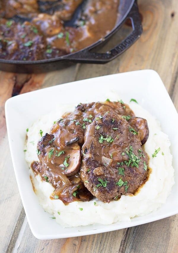 Salisbury Steak with Mushrooms and Creamy Mashed Potaotes- This is classic comfort food, but I promise it tastes way better than frozen or what you may remember from your school cafeteria! Serve it with the creamy mashed potatoes and you have a wonderfully satisfying meal! | Countryside Cravings