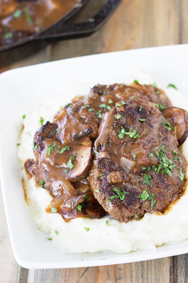 Salisbury Steak with Mushrooms and Creamy Mashed Potaotes- This is classic comfort food, but I promise it tastes way better than frozen or what you may remember from your school cafeteria! Serve it with the creamy mashed potatoes and you have a wonderfully satisfying meal! | Countryside Cravings