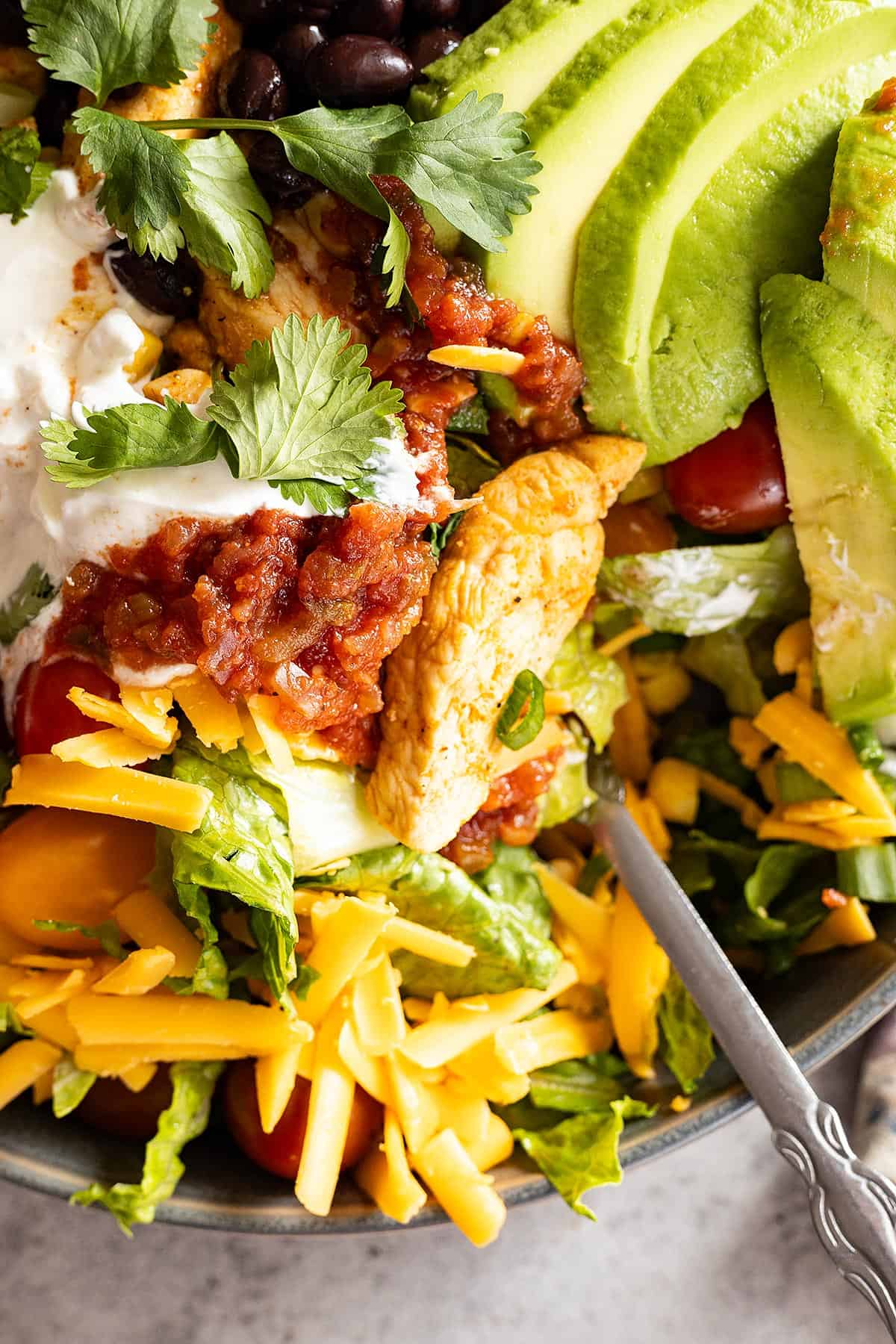 Close up of Chicken Taco Bowl with a fork in the salad. 