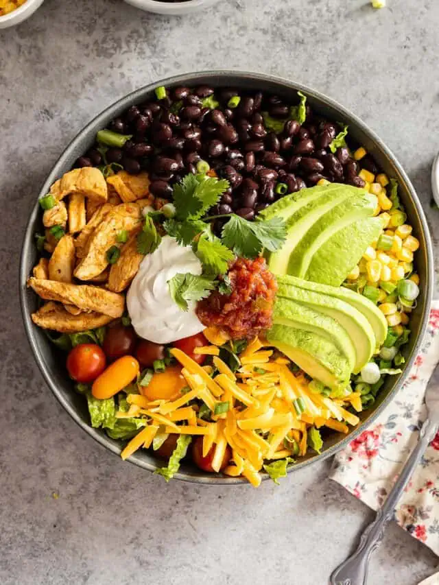 Overhead view of taco bowl with fork and napkin off to the side.