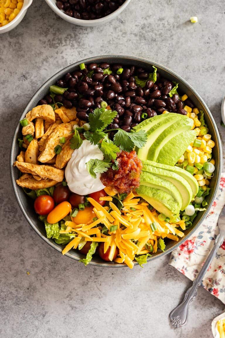 Overhead view of taco bowl with fork and napkin off to the side.