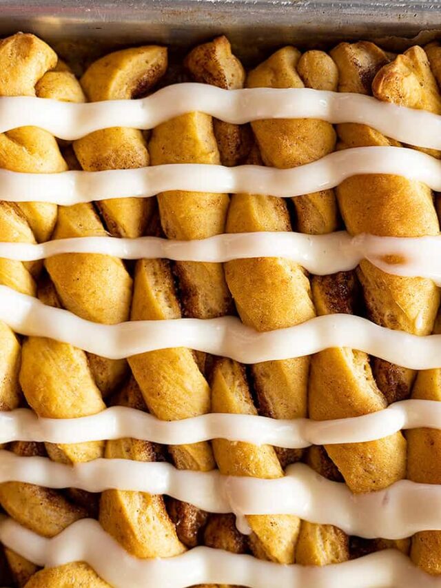 Overhead view of pumpkin twists with cream cheese frosting drizzled over them.