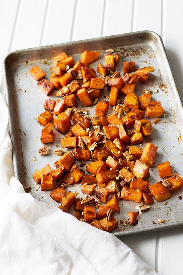 Maple Roasted Sweet Potatoes- these are lightly sweetened with maple syrup, spiced with cinnamon and have an optional crunch from pecans, YUM! | countrysidecravings.com