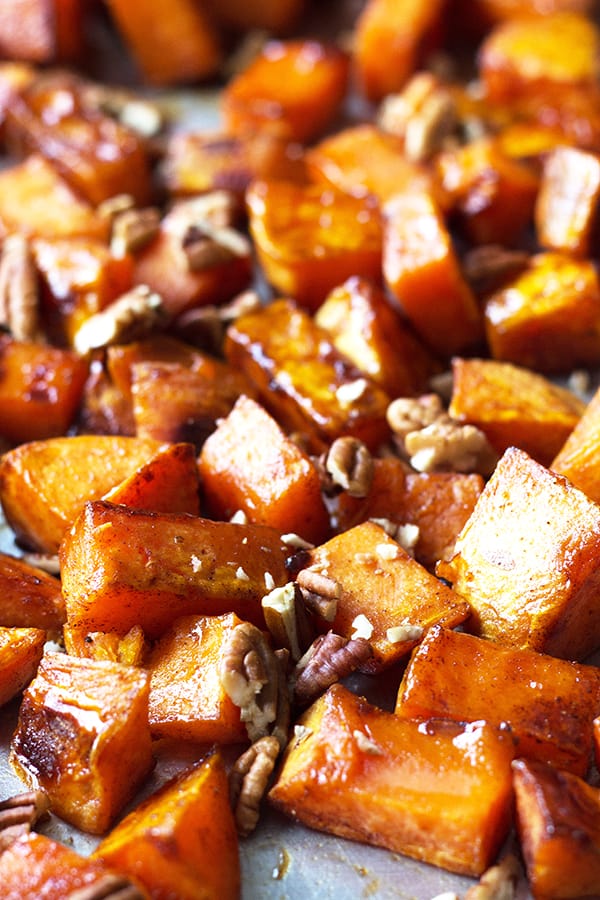 Maple Roasted Sweet Potatoes- these are lightly sweetened with maple syrup, spiced with cinnamon and have an optional crunch from pecans, YUM! | countrysidecravings.com