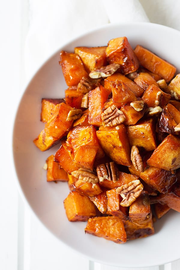 Maple Roasted Sweet Potatoes- these are lightly sweetened with maple syrup, spiced with cinnamon and have an optional crunch from pecans, YUM! | countrysidecravings.com