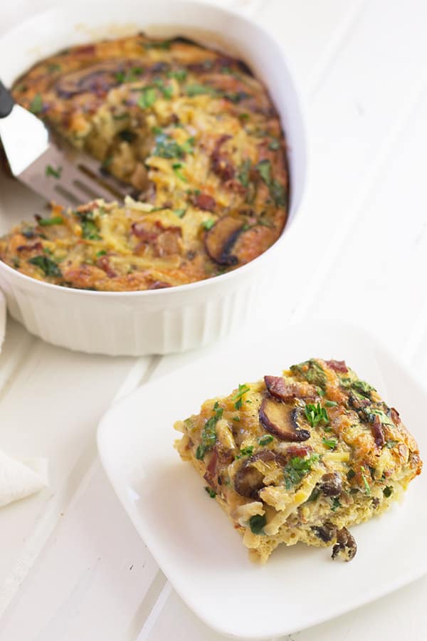 a square slice of bacon, mushroom, and spinach in a breakfast casserole