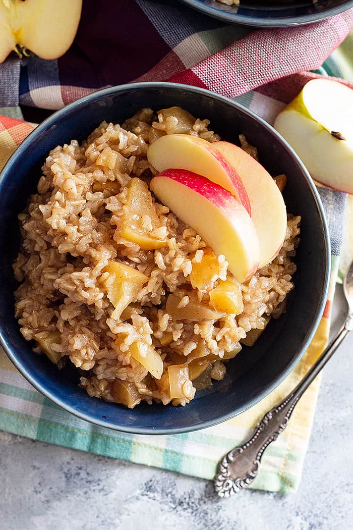 Top down view of Slow Cooker Cinnamon Apple Breakfast Rice topped with fresh apple slices.