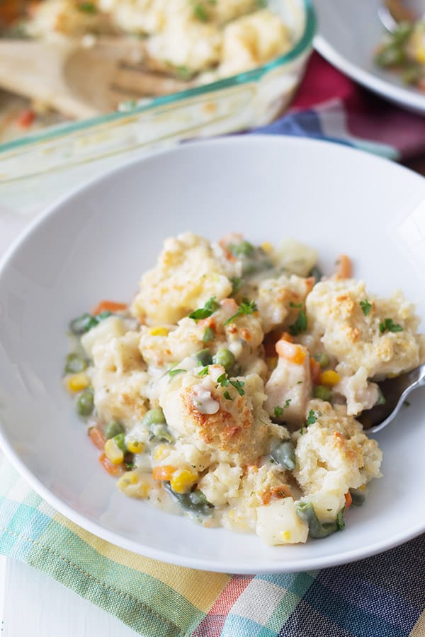 homemade chicken pot pie in a white bowl with crumble crust on top