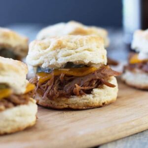 BBQ Pulled Pork Biscuit Sliders -perfect little sandwiches with smokey pulled pork, melted cheddar and Dijon mustard. | countrysidecravings.com
