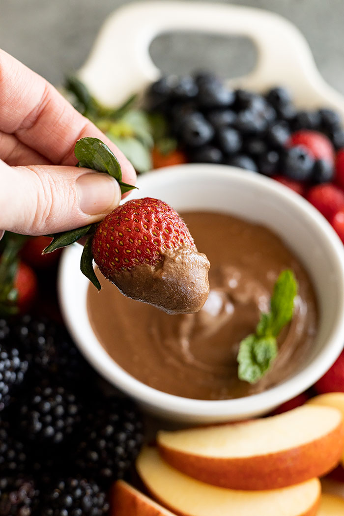 Strawberry dipped into the fruit dip.