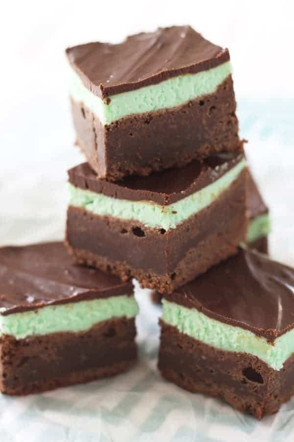 A stack of chocolate mint brownies. There are 4 brownies shown.