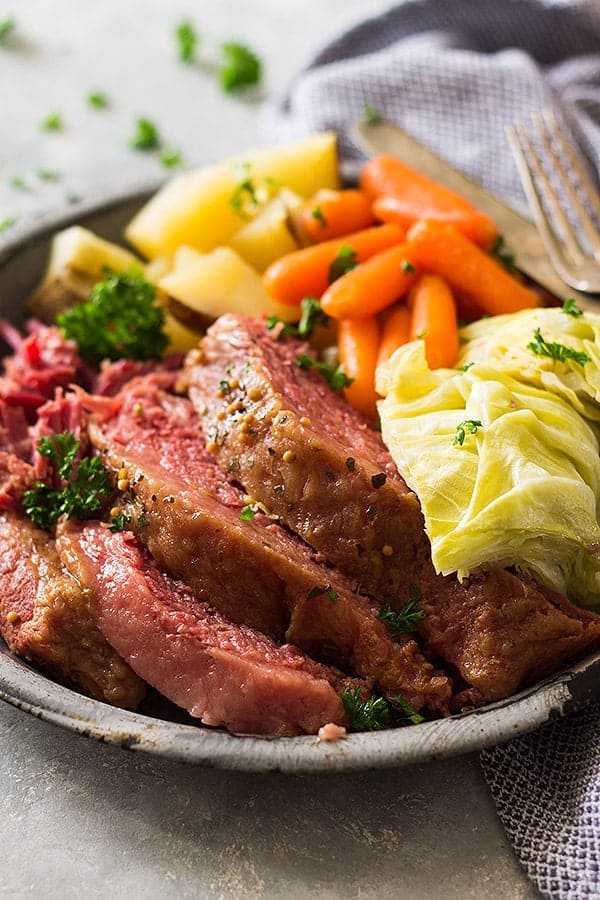 A large plate of sliced corned beef, cabbage, carrots, and potatoes. 