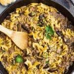 A top down view of one pot hamburger stroganoff in a pan with a spoon.