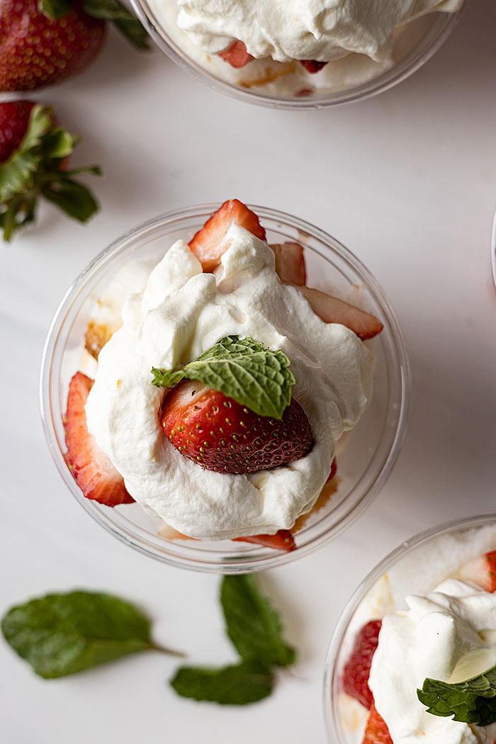 Overhead close up of shortcake cup. Mint scattered around.