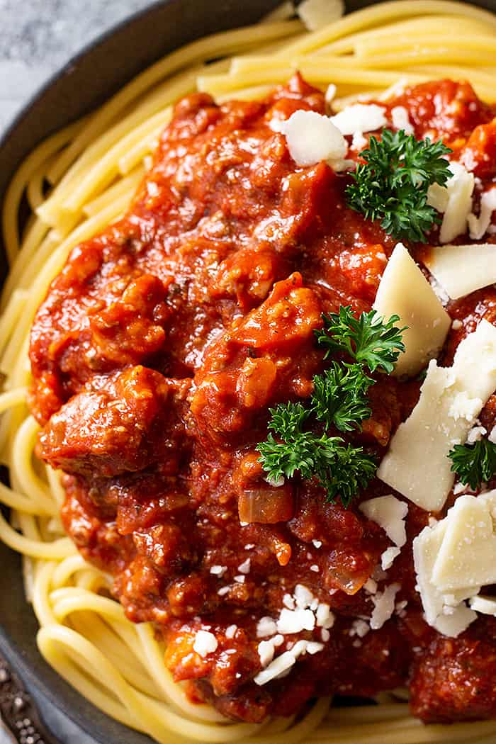 Close up of spaghetti sauce on pasta and topped with cheese. 