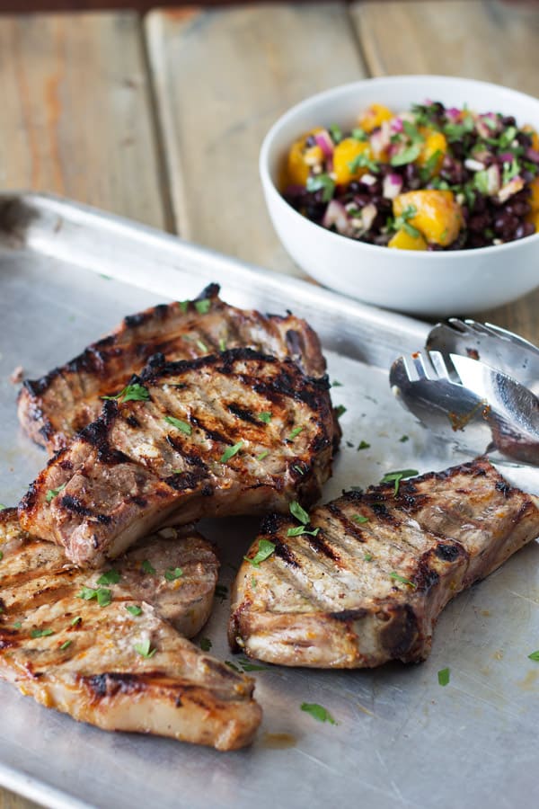 Citrus marinated pork chops fresh off the grill with mango and black bean salsa on the side
