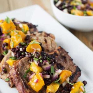 Citrus Marinated Pork Chops with Mango Black Bean Salsa -a juicy marinated pork chop grilled to perfection. Topped with a sweet and savory mango salsa! | www.countrysidecravings.com