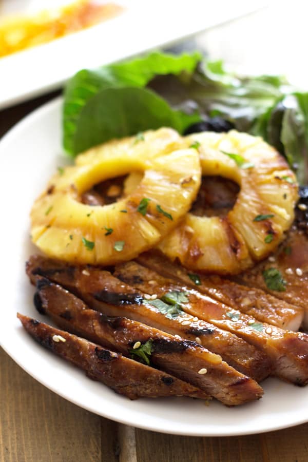 grilled teriyaki marinated pork chops with grilled pineapple served over greens