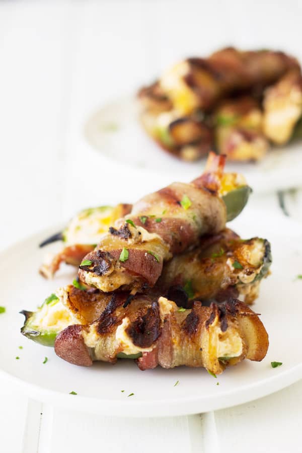 Grilled Jalapeno Poppers filled with a creamy cheese mixture and wrapped in smoky bacon