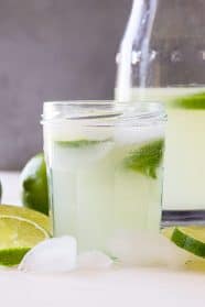 A refreshing glass of limeade with slices of fresh lime.